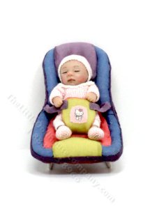 (image for) Waking Baby Girl in a Carrier by Catherine Muniere