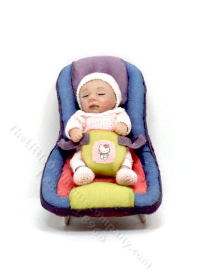 (image for) Waking Baby Girl in a Carrier by Catherine Muniere