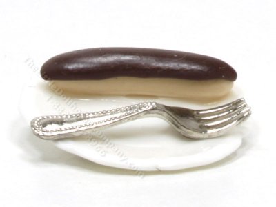 (image for) Miniature Éclair on White Plate with Fork by Charlotte Willmott