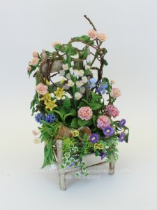 (image for) Miniature Garden Chair Over Growing with Spring Flowers