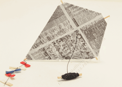(image for) Miniature Newsprint Kite with Spool and Decorative Bows.