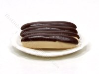 (image for) 4 Miniature Éclairs on White Ceramic Plate by Charlotte Willmott