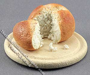 (image for) Miniature Round Bread Loaf Sliced on Breadboard